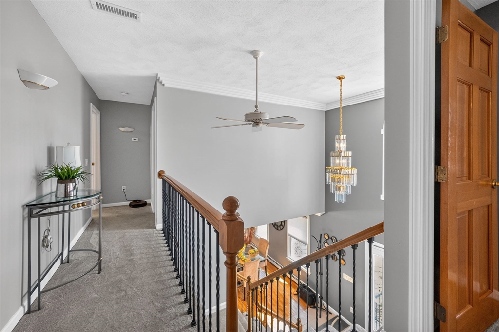 22 McRayne Hill Road Billerica, MA 01821 - Photo 31 of 42 a view of a hallway with wooden floor and stairs