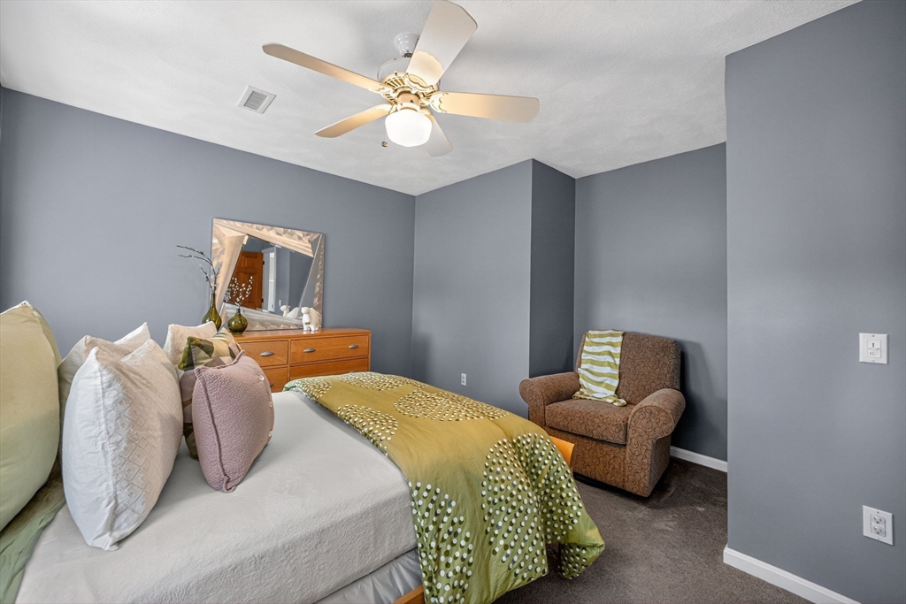 22 McRayne Hill Road Billerica, MA 01821 - Photo 32 of 42 a bedroom with a bed and ceiling fan