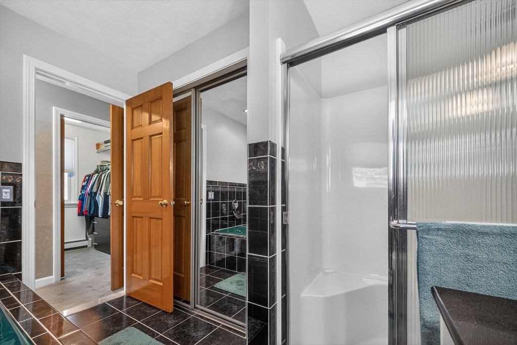 22 McRayne Hill Road Billerica, MA 01821 - Photo 36 of 42 a bathroom with a shower and a mirror