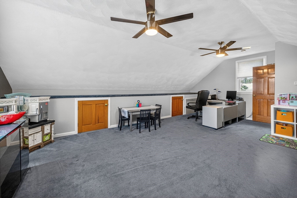 22 McRayne Hill Road Billerica, MA 01821 - Photo 38 of 42 a living room with furniture and a chandelier