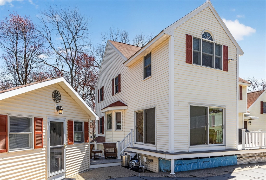 22 McRayne Hill Road Billerica, MA 01821 - Photo 41 of 42 a view of a white house with large windows and wooden fence