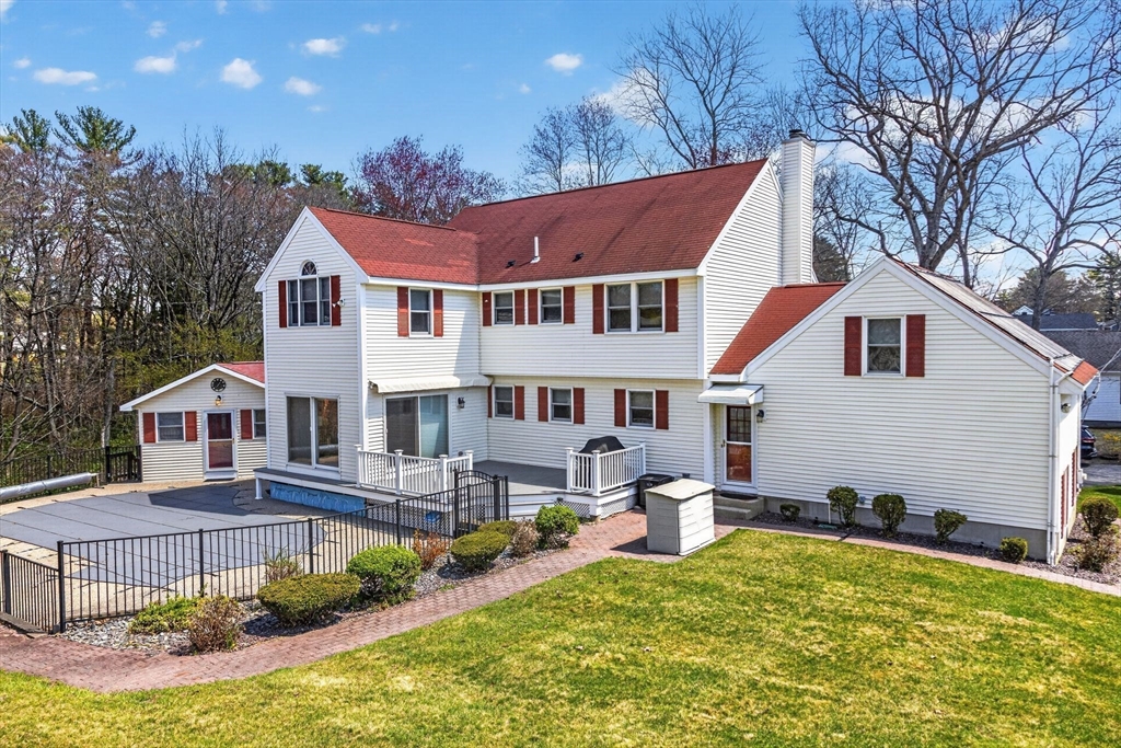 22 McRayne Hill Road Billerica, MA 01821 - Photo 42 of 42 a front view of a house with a yard table and chairs