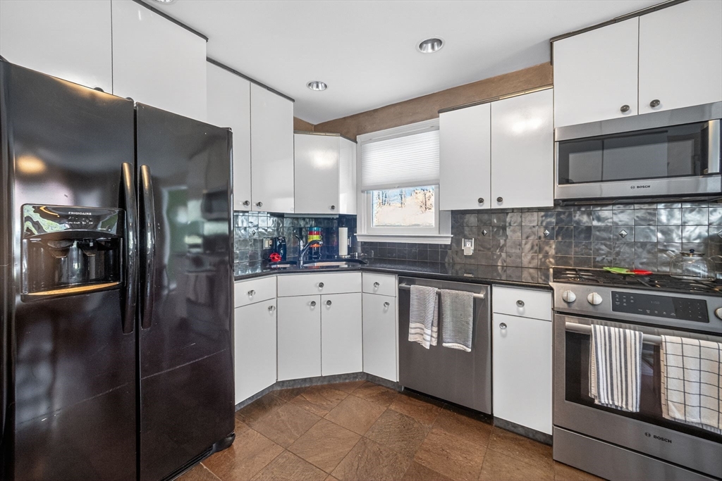 22 McRayne Hill Road Billerica, MA 01821 - Photo 5 of 42 a kitchen with stainless steel appliances granite countertop a refrigerator a stove and a sink