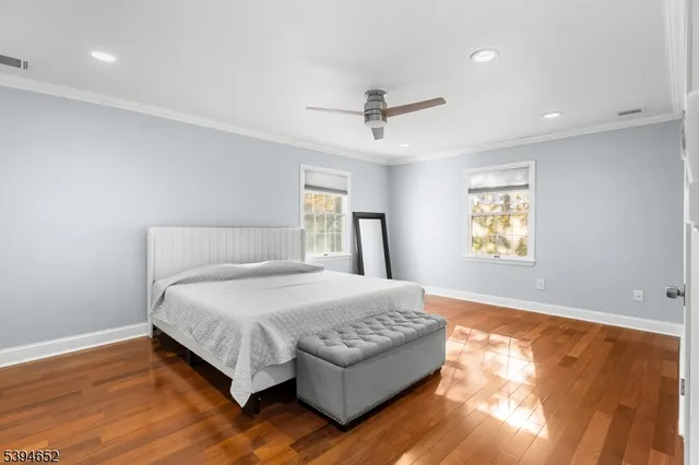 a bedroom with a bed couch and window