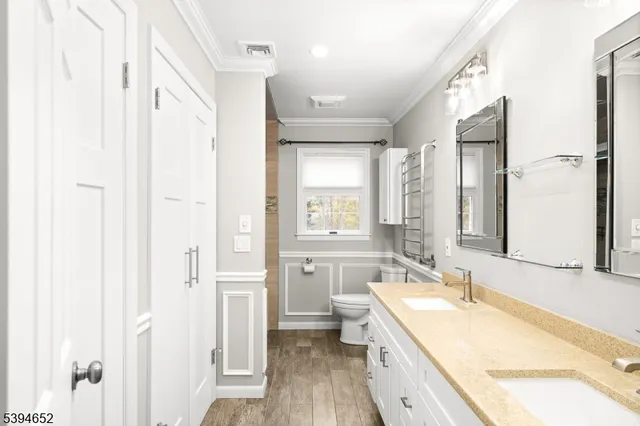 a bathroom with a granite countertop sink mirror vanity and a bathtub