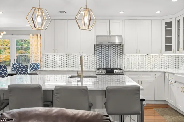 a kitchen with stainless steel appliances granite countertop a sink and cabinets