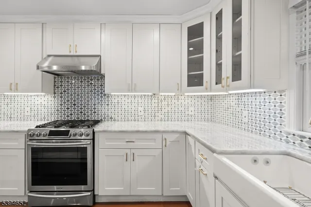 a kitchen with a sink stove and cabinets