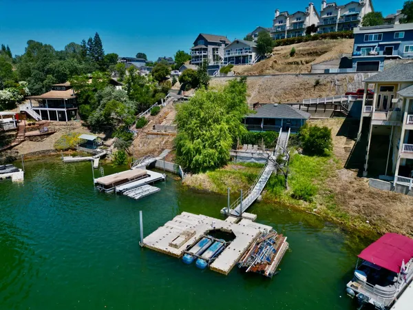 a aerial view of a house with swimming pool garden and outdoor seating