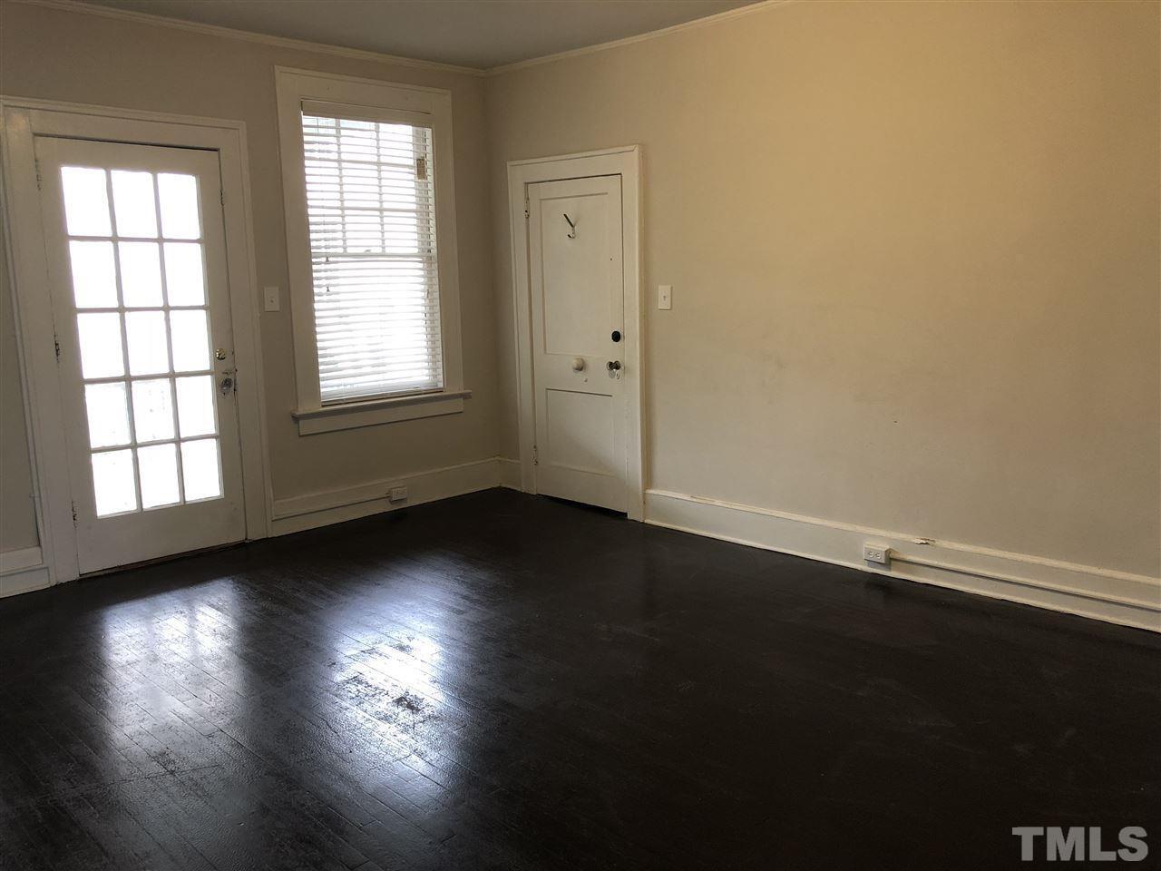 200 East Edenton Street, Unit 4 Raleigh, NC 27601 - Photo 4 of 17 an empty room with wooden floor and windows