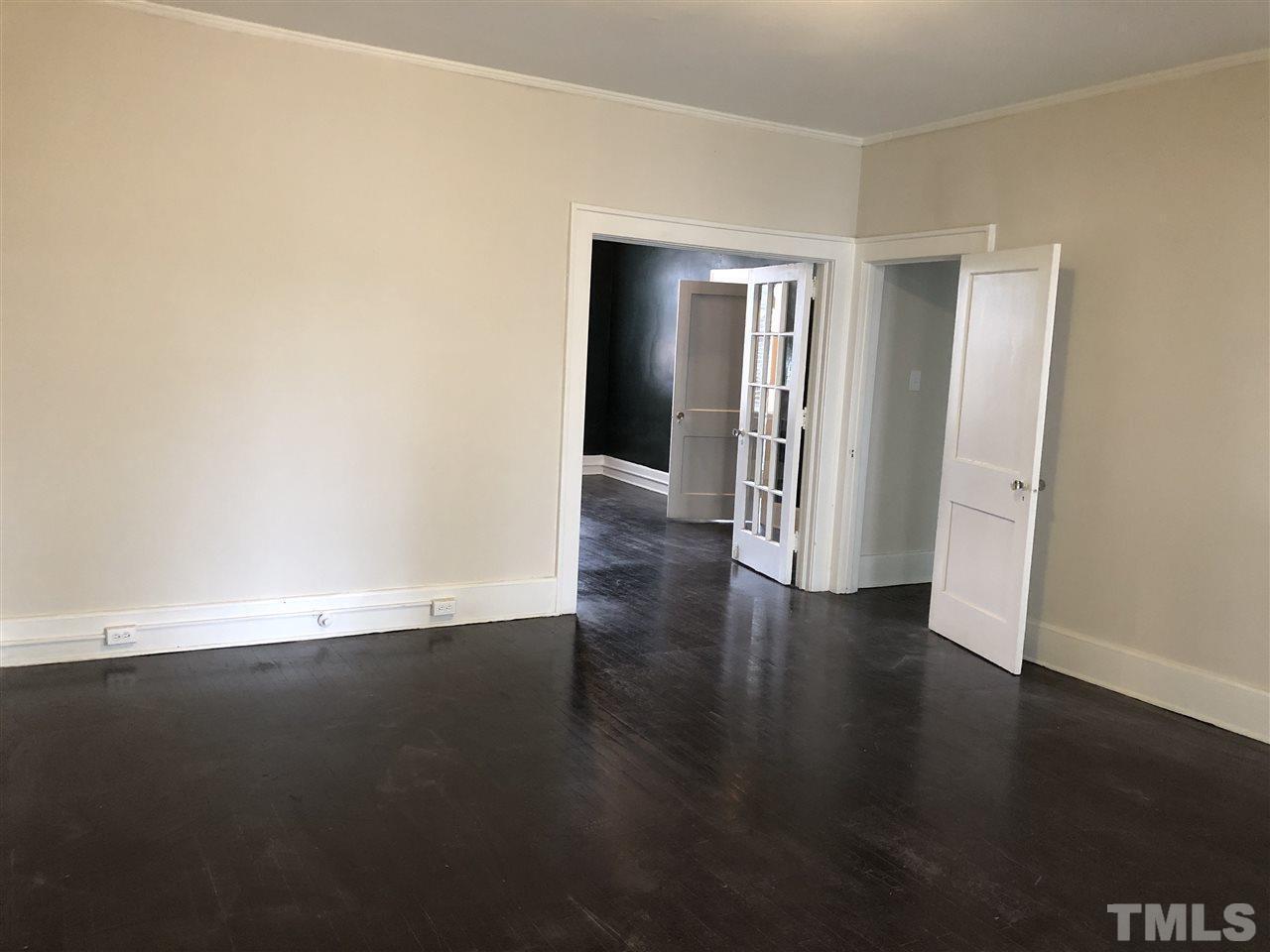 200 East Edenton Street, Unit 4 Raleigh, NC 27601 - Photo 6 of 17 a view of an empty room with wooden floor and closet