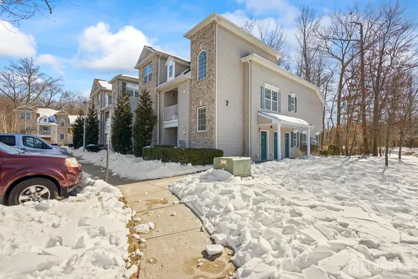 a view of a house with a yard covered in snow