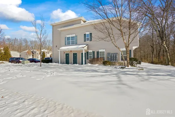 a front view of a building with trees