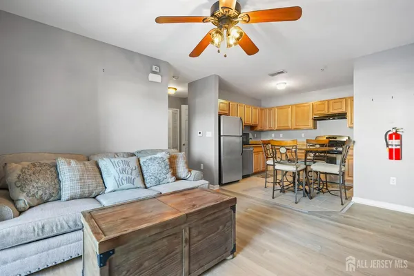 a living room with furniture and kitchen view