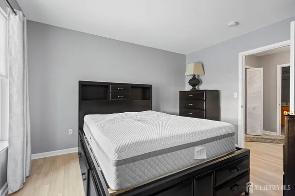 a bedroom with a bed and dresser