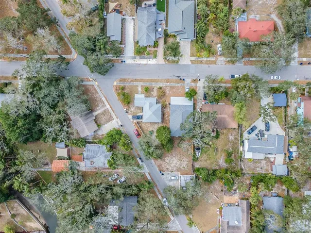 an aerial view of multiple houses with yard