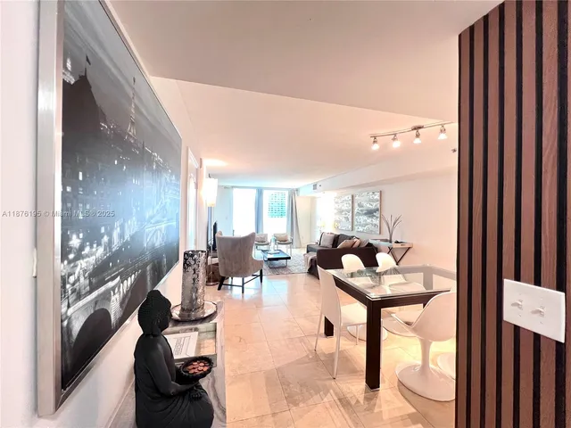 a living room with fireplace furniture and a large window