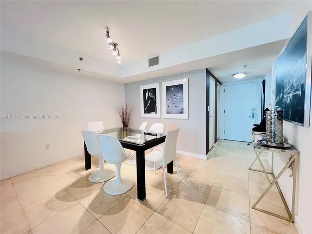 a view of a livingroom with furniture and a to ceiling window