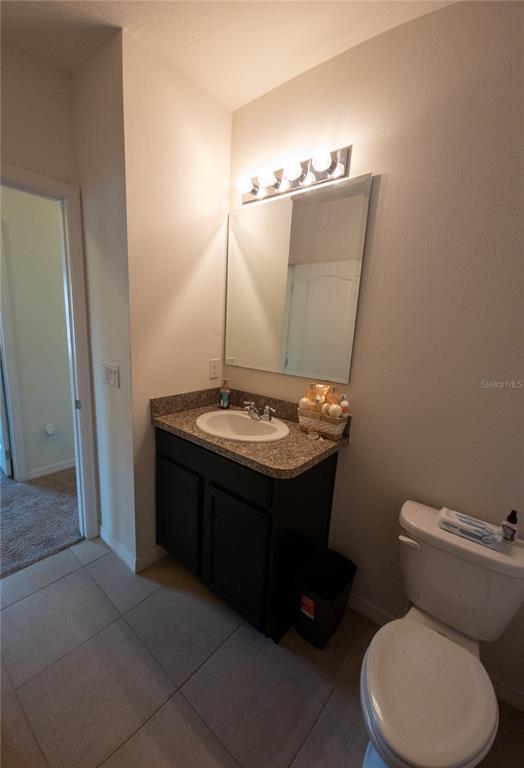 3724 Seneca Club Loop, Unit 41103 Orlando, FL 32808 - Photo 16 of 27 a bathroom with a sink vanity mirror and toilet