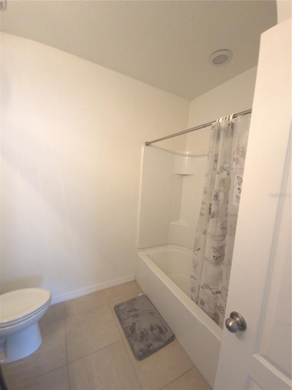 3724 Seneca Club Loop, Unit 41103 Orlando, FL 32808 - Photo 17 of 27 a bathroom with a shower and a toilet