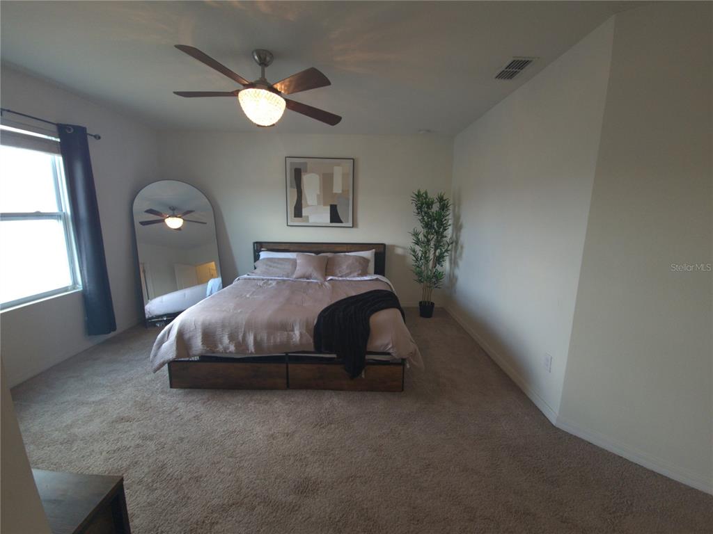 3724 Seneca Club Loop, Unit 41103 Orlando, FL 32808 - Photo 20 of 27 a bedroom with a bed and a window