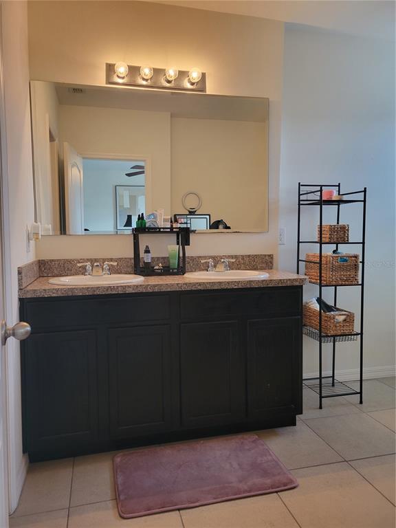 3724 Seneca Club Loop, Unit 41103 Orlando, FL 32808 - Photo 22 of 27 a bathroom with a sink and a mirror