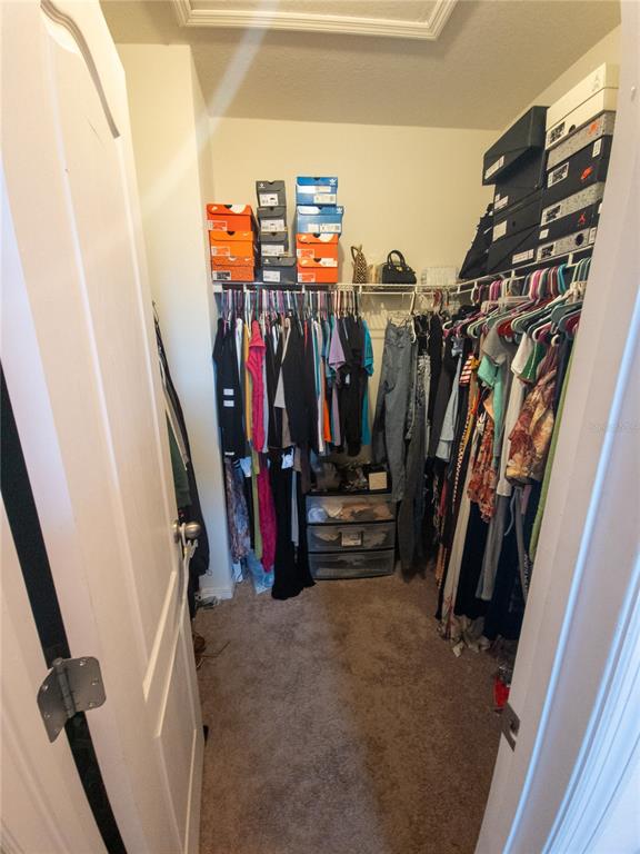3724 Seneca Club Loop, Unit 41103 Orlando, FL 32808 - Photo 25 of 27 a view of walk in closet with clothes
