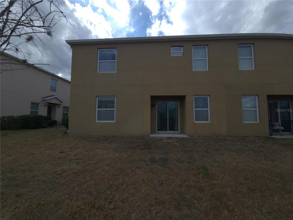 3724 Seneca Club Loop, Unit 41103 Orlando, FL 32808 - Photo 26 of 27 a backyard of a house with lots of green space