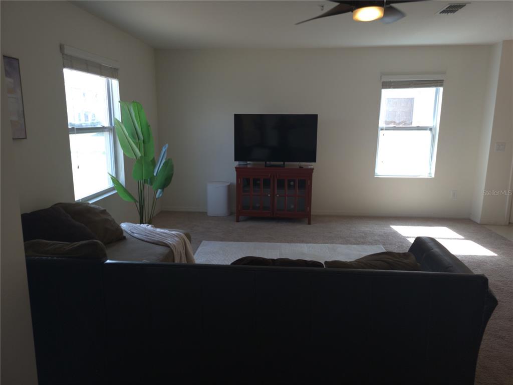 3724 Seneca Club Loop, Unit 41103 Orlando, FL 32808 - Photo 4 of 27 a bedroom with bed and window