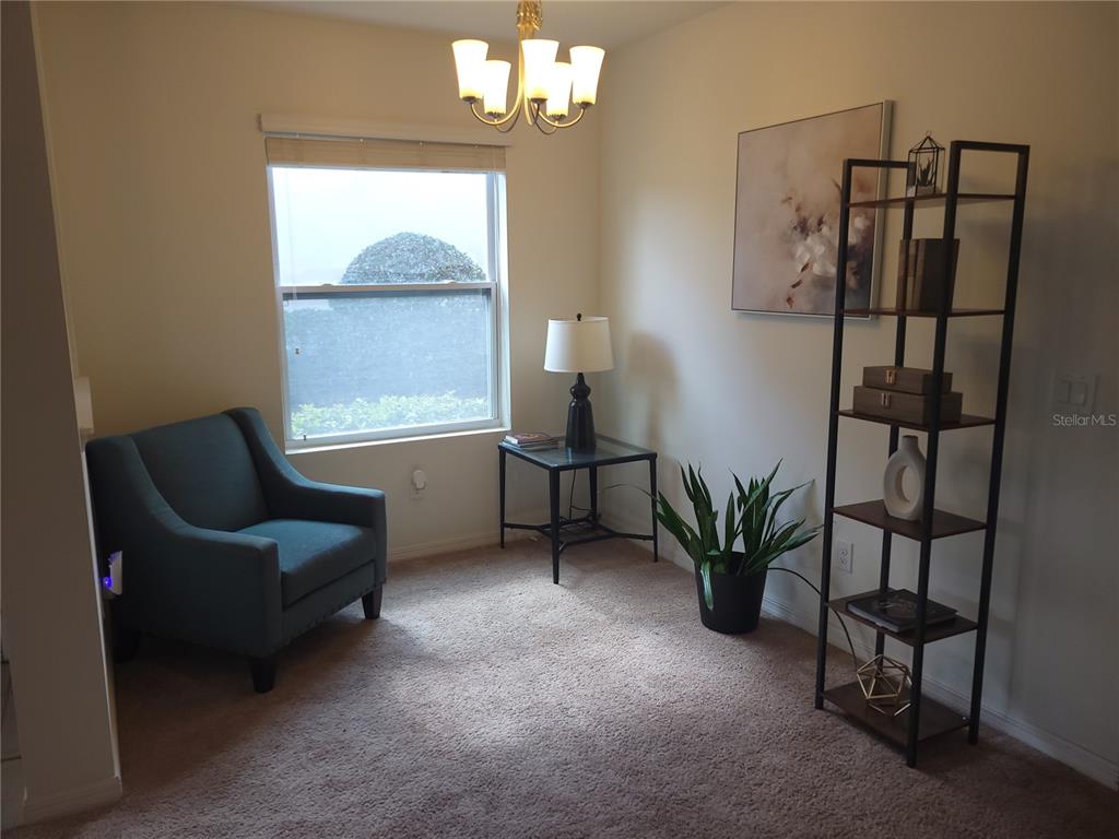 3724 Seneca Club Loop, Unit 41103 Orlando, FL 32808 - Photo 8 of 27 a living room with furniture and a window