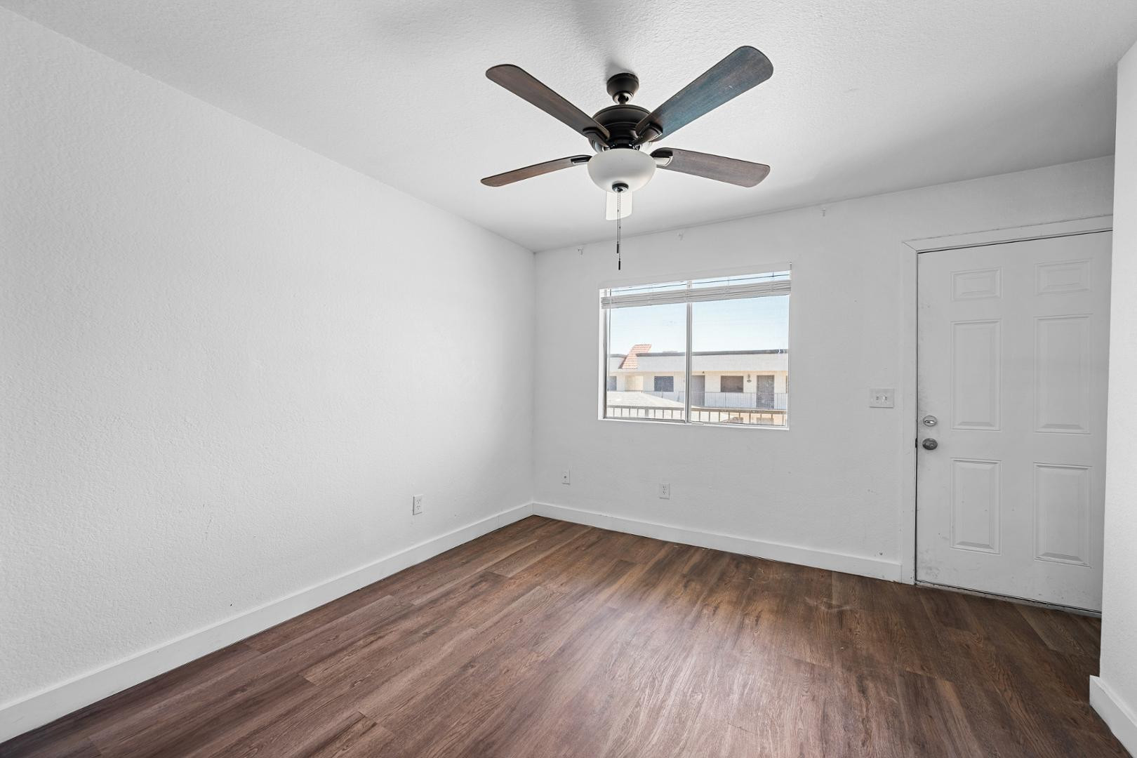 18202 North Cave Creek Road, Unit 252 Phoenix, AZ 85032 - Photo 13 of 15 an empty room with wooden floor and windows