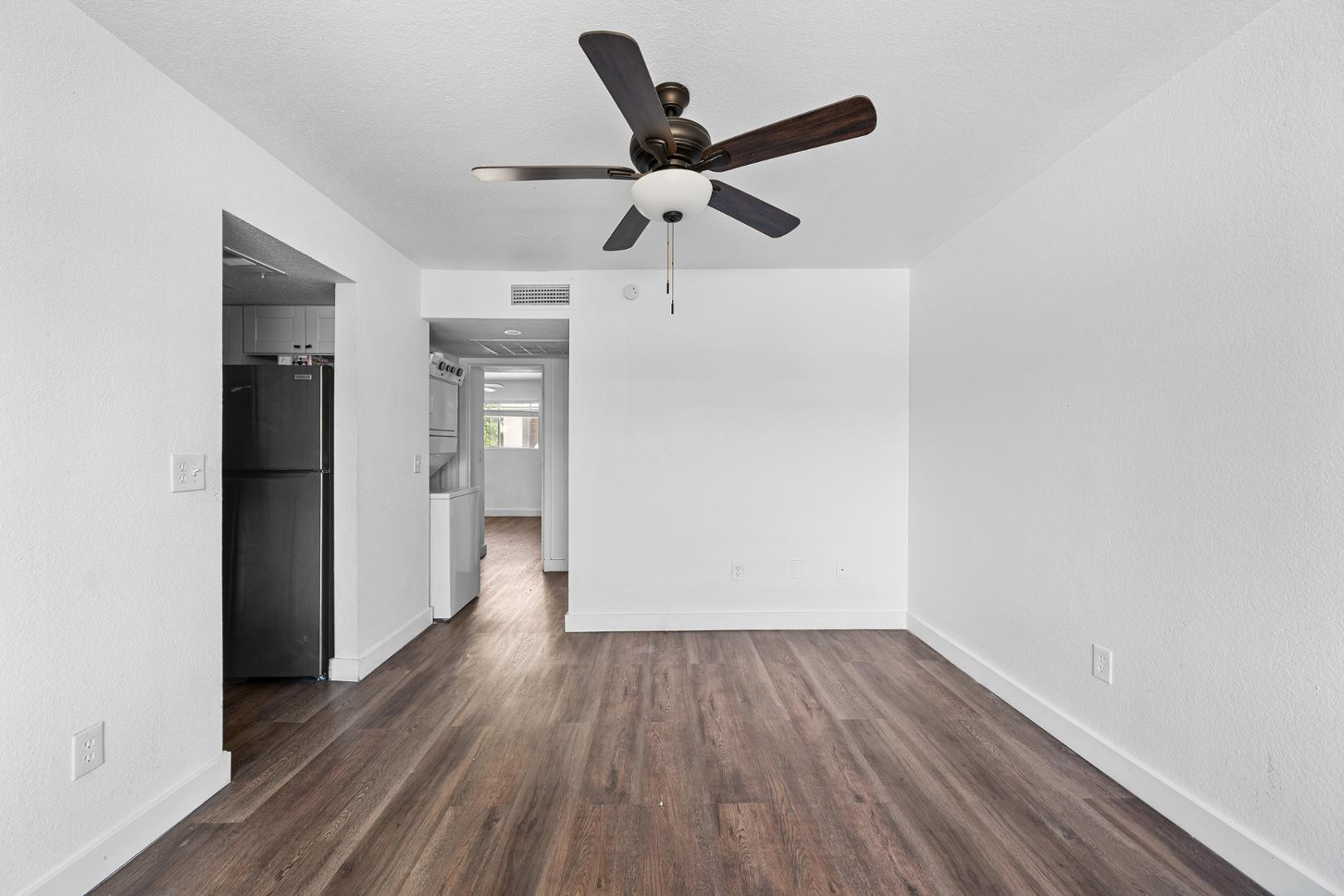 18202 North Cave Creek Road, Unit 252 Phoenix, AZ 85032 - Photo 14 of 15 a view of empty room with wooden floor and ceiling fan