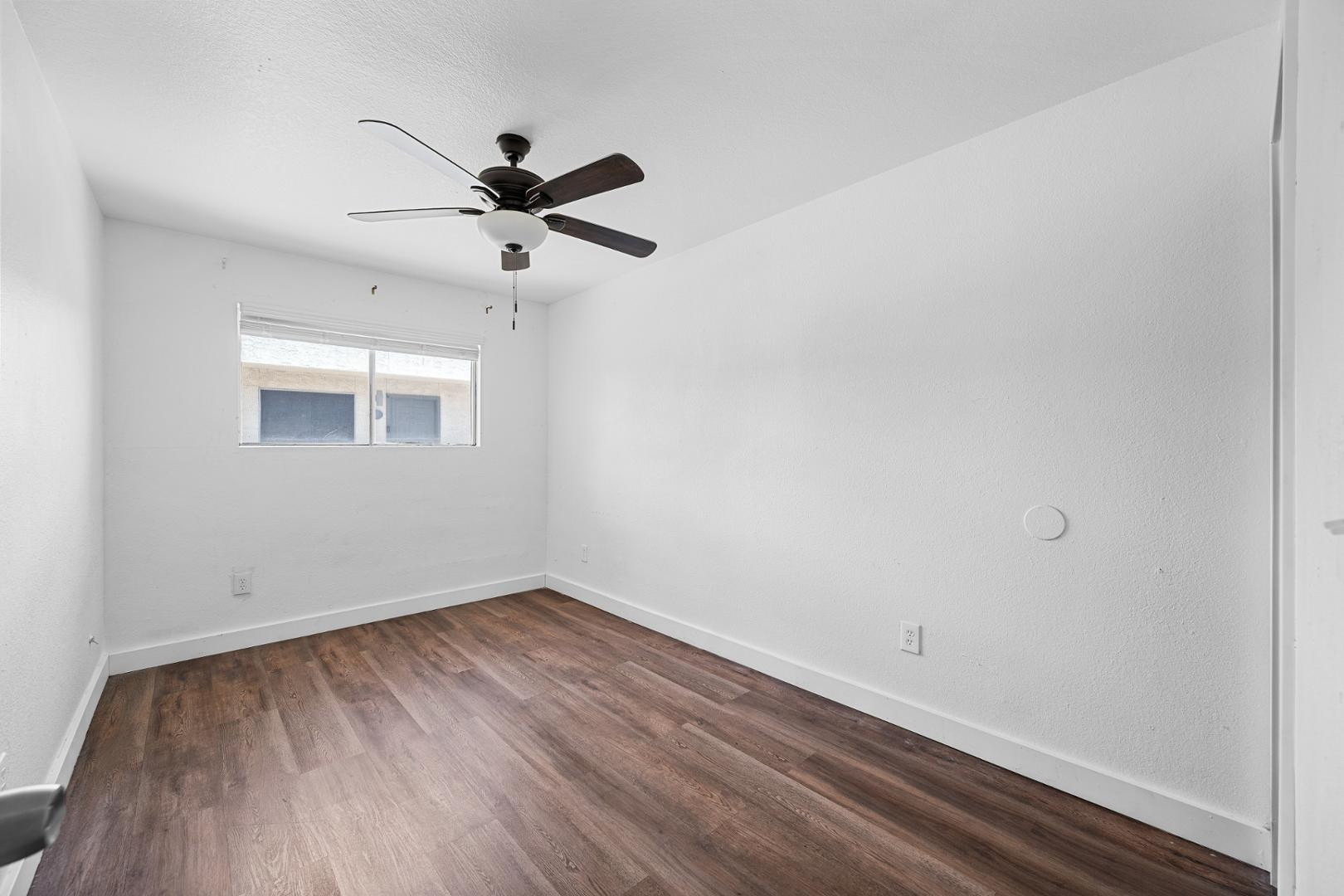 18202 North Cave Creek Road, Unit 252 Phoenix, AZ 85032 - Photo 4 of 15 wooden floor in an empty room with a window
