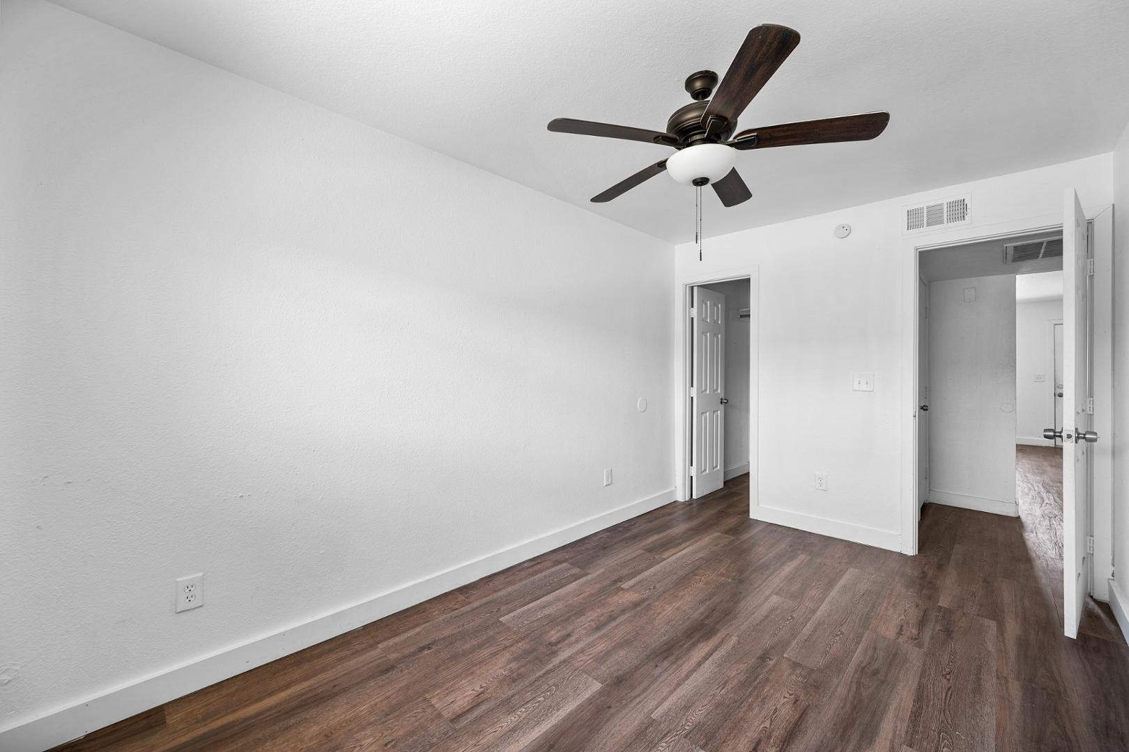 18202 North Cave Creek Road, Unit 252 Phoenix, AZ 85032 - Photo 5 of 15 a view of empty room with wooden floor and ceiling fan