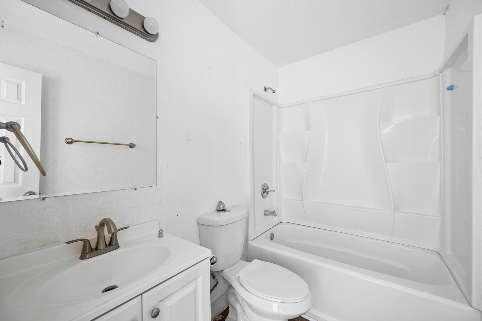 18202 North Cave Creek Road, Unit 252 Phoenix, AZ 85032 - Photo 9 of 15 a bathroom with a bathtub shower sink vanity mirror and toilet