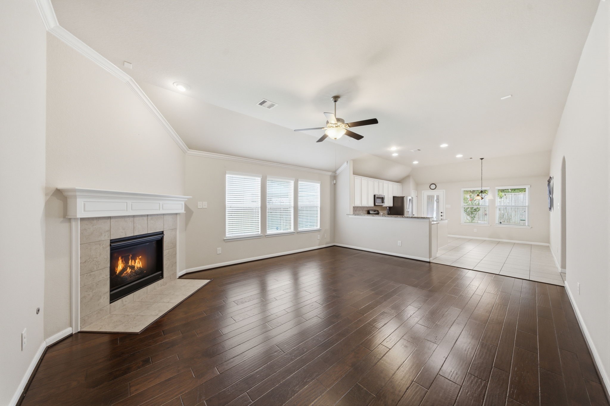 7611 Willow School Drive Spring, TX 77389 - Photo 6 of 23 a view of an empty room with wooden floor fireplace and a window