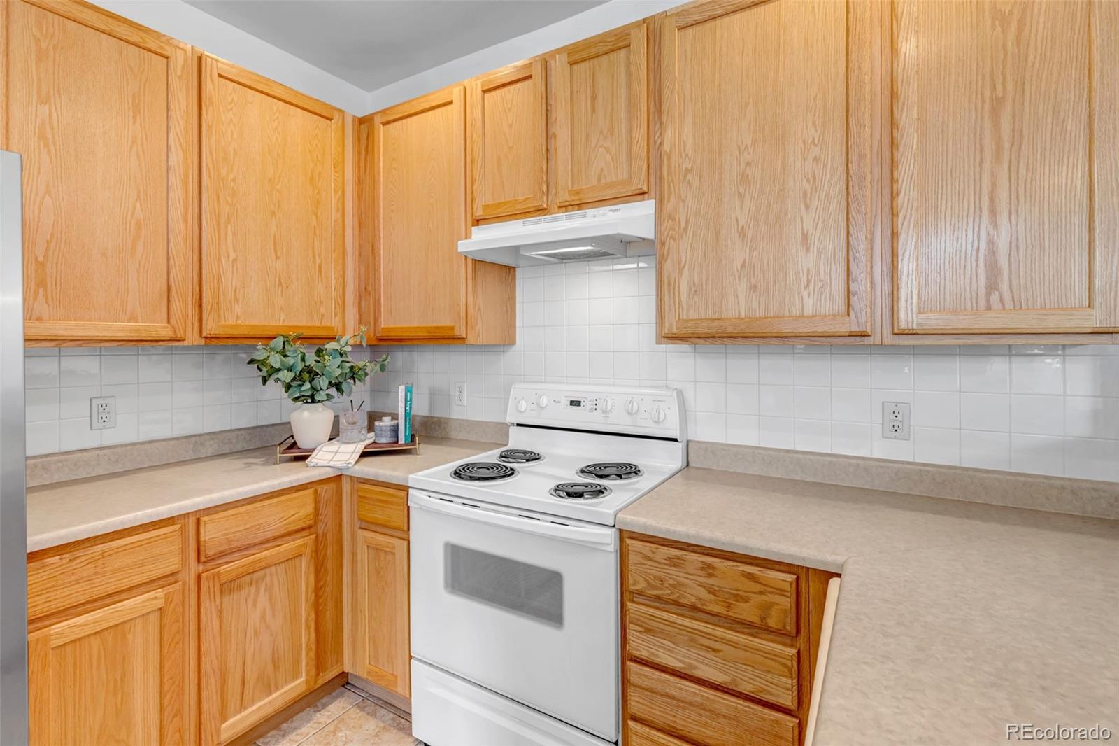 1237 Carlyle Park Circle Highlands Ranch, CO 80129 - Photo 11 of 33 a kitchen with granite countertop cabinets sink and white appliances