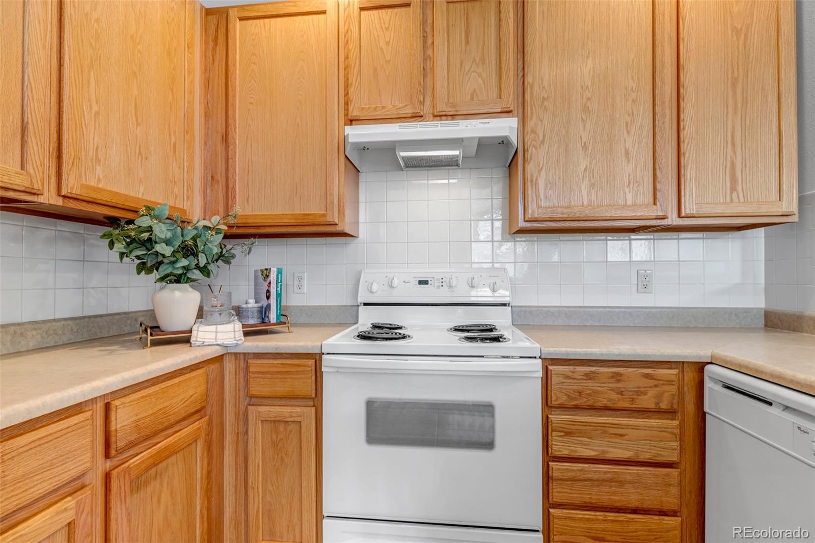 1237 Carlyle Park Circle Highlands Ranch, CO 80129 - Photo 12 of 33 a kitchen with granite countertop cabinets sink and white appliances