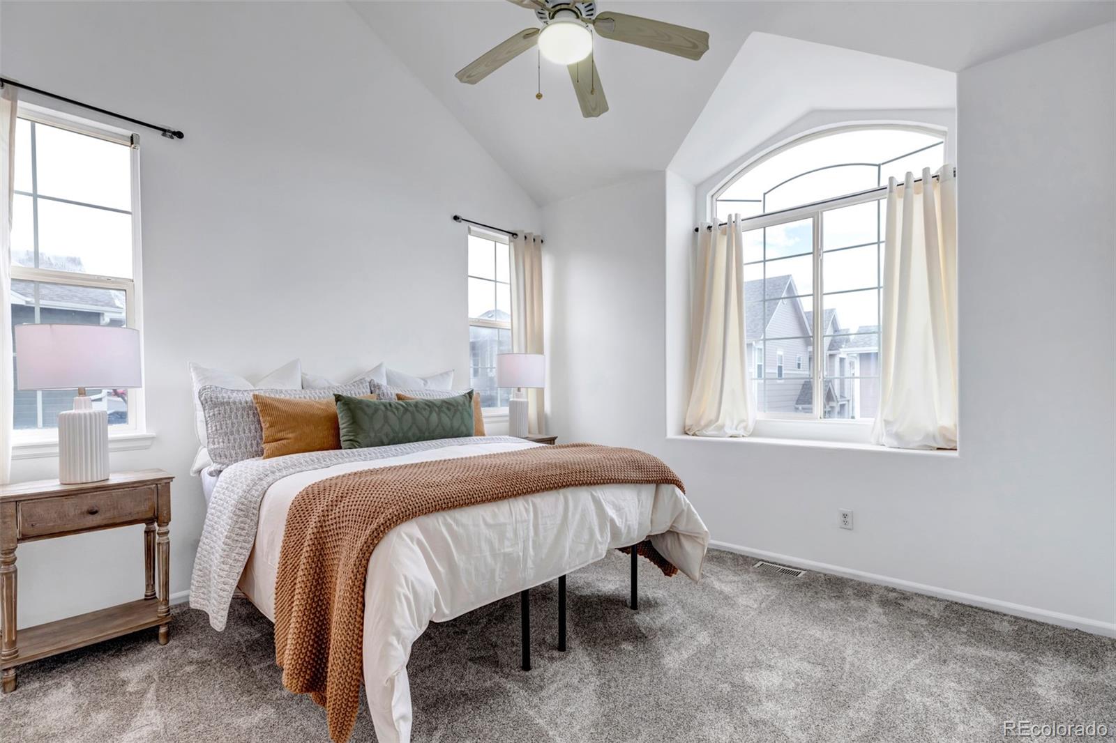 1237 Carlyle Park Circle Highlands Ranch, CO 80129 - Photo 14 of 33 a bedroom with a large bed and a chandelier fan