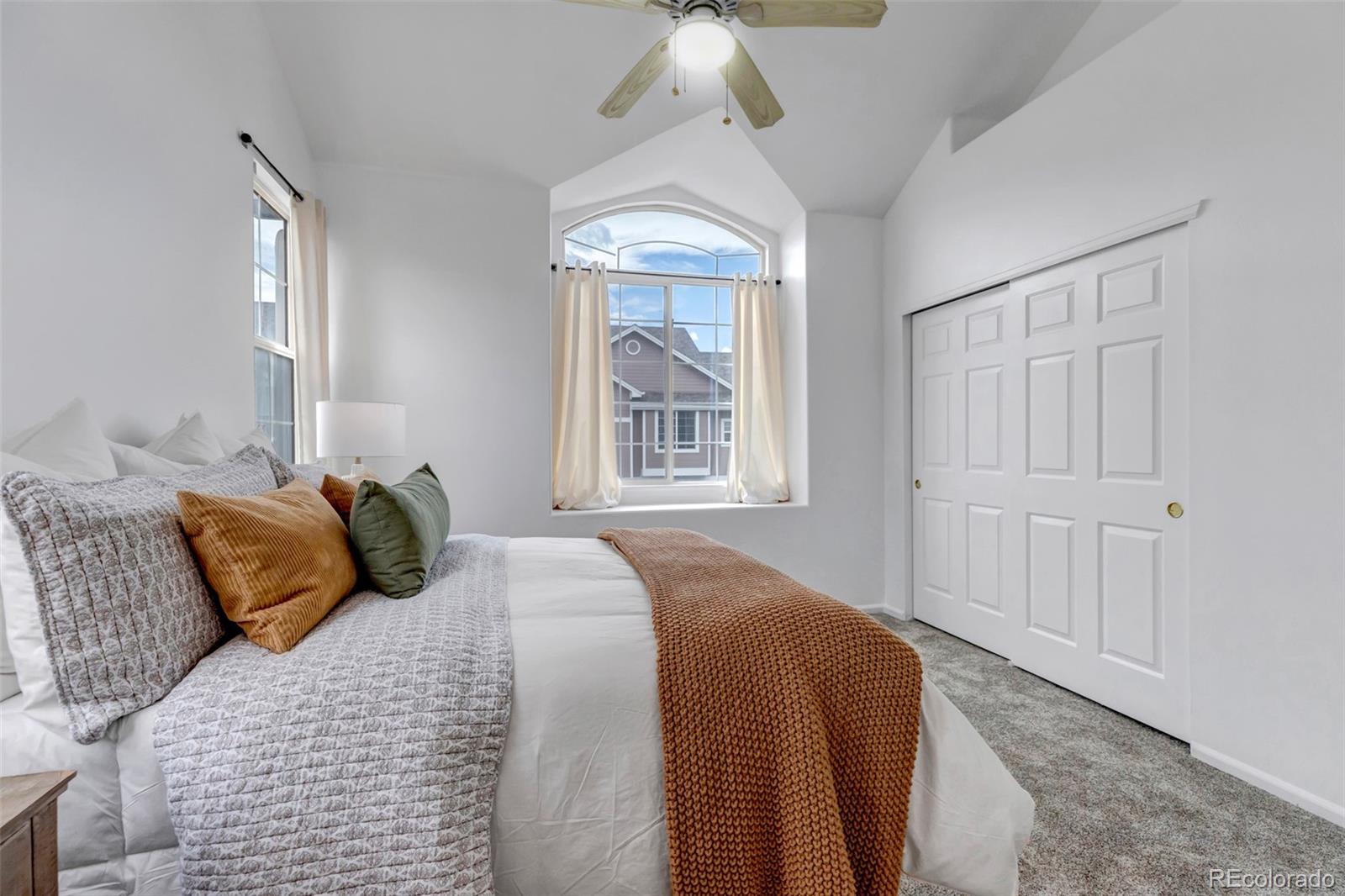 1237 Carlyle Park Circle Highlands Ranch, CO 80129 - Photo 18 of 33 a bedroom with a large bed and a chandelier