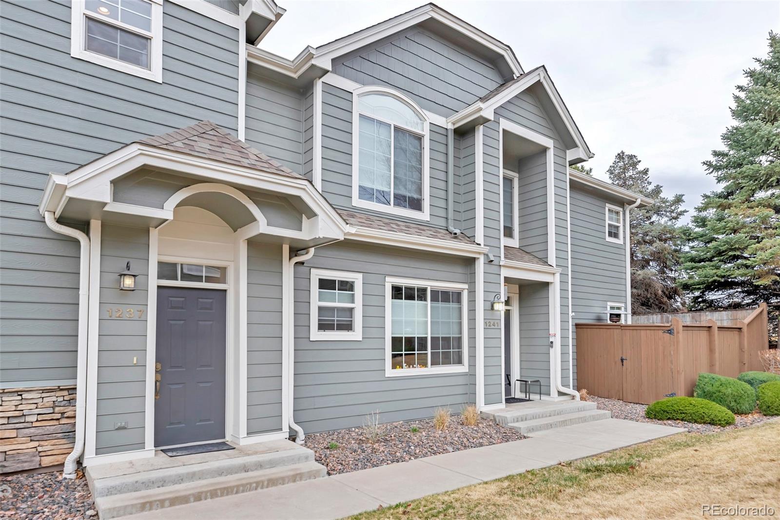 1237 Carlyle Park Circle Highlands Ranch, CO 80129 - Photo 2 of 33 a front view of a house with a yard