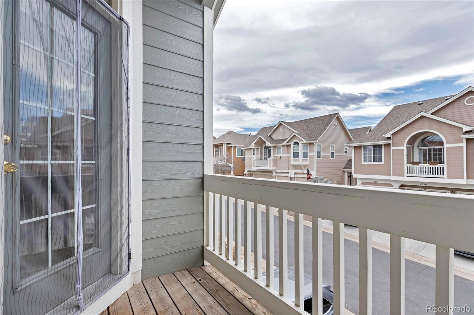 1237 Carlyle Park Circle Highlands Ranch, CO 80129 - Photo 27 of 33 a view of a balcony with wooden floor and fence