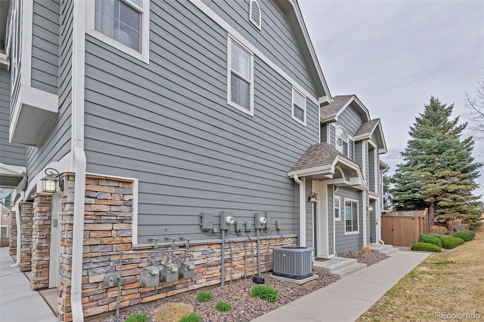 1237 Carlyle Park Circle Highlands Ranch, CO 80129 - Photo 29 of 33 a front view of a house with a yard