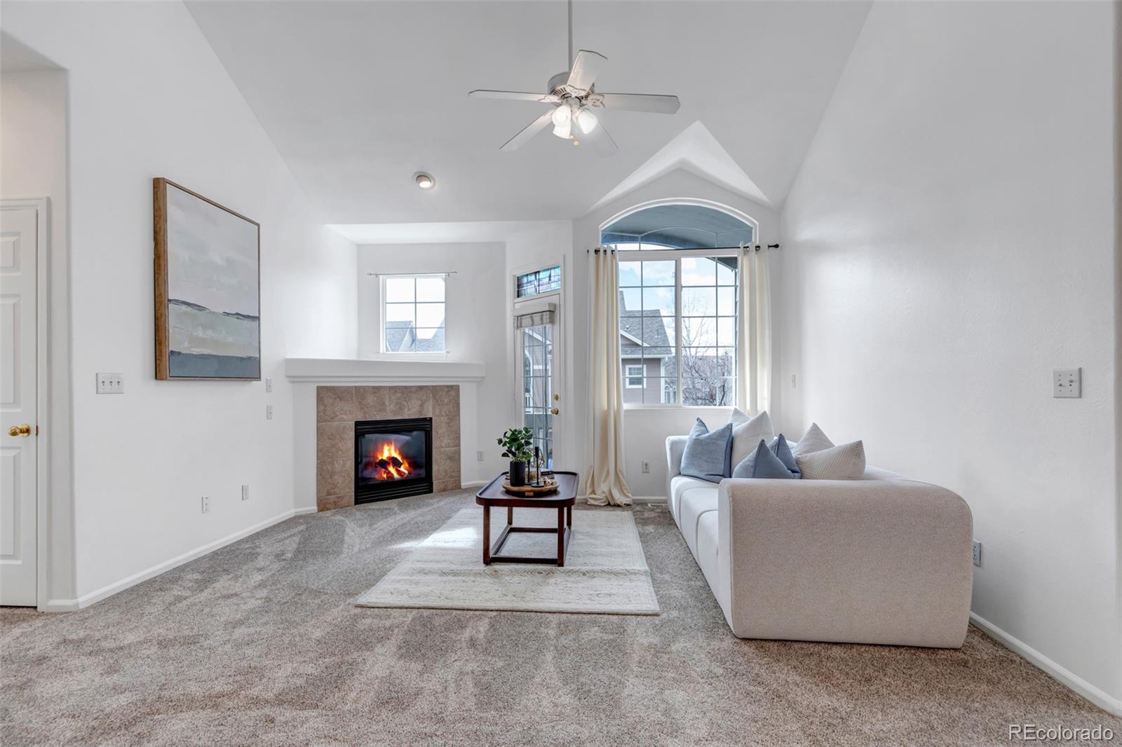 1237 Carlyle Park Circle Highlands Ranch, CO 80129 - Photo 5 of 33 a living room with furniture a fireplace and a chandelier