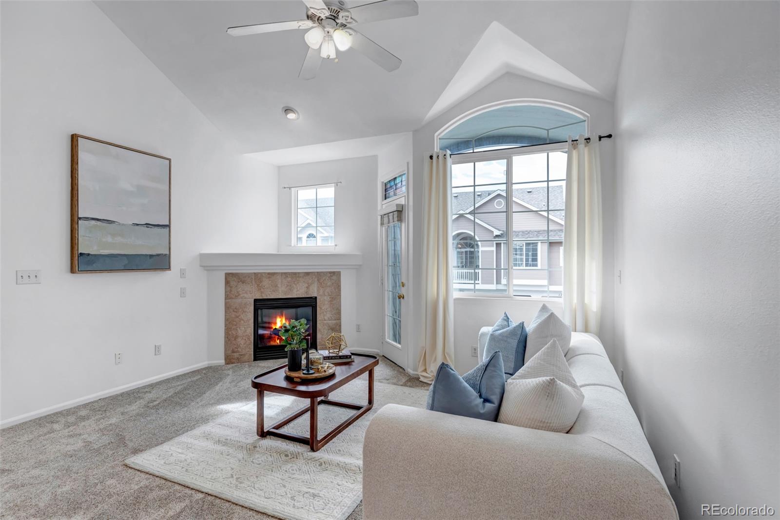 1237 Carlyle Park Circle Highlands Ranch, CO 80129 - Photo 6 of 33 a living room with furniture a fireplace and a large window