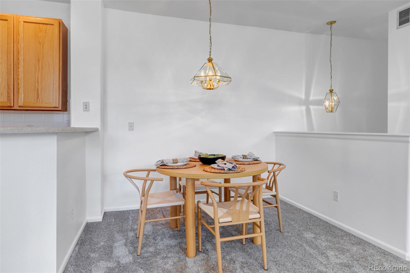 1237 Carlyle Park Circle Highlands Ranch, CO 80129 - Photo 9 of 33 a dining room with a table and chairs