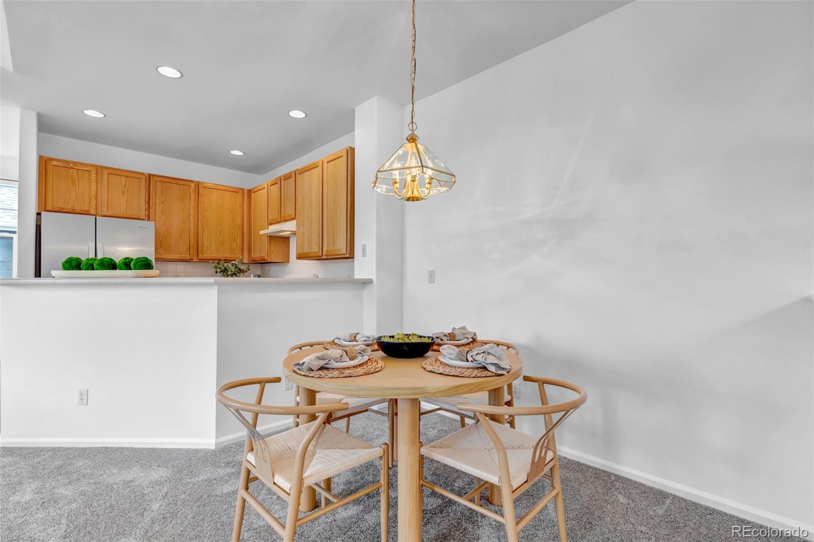 1237 Carlyle Park Circle Highlands Ranch, CO 80129 - Photo 10 of 33 a table and chairs in a kitchen