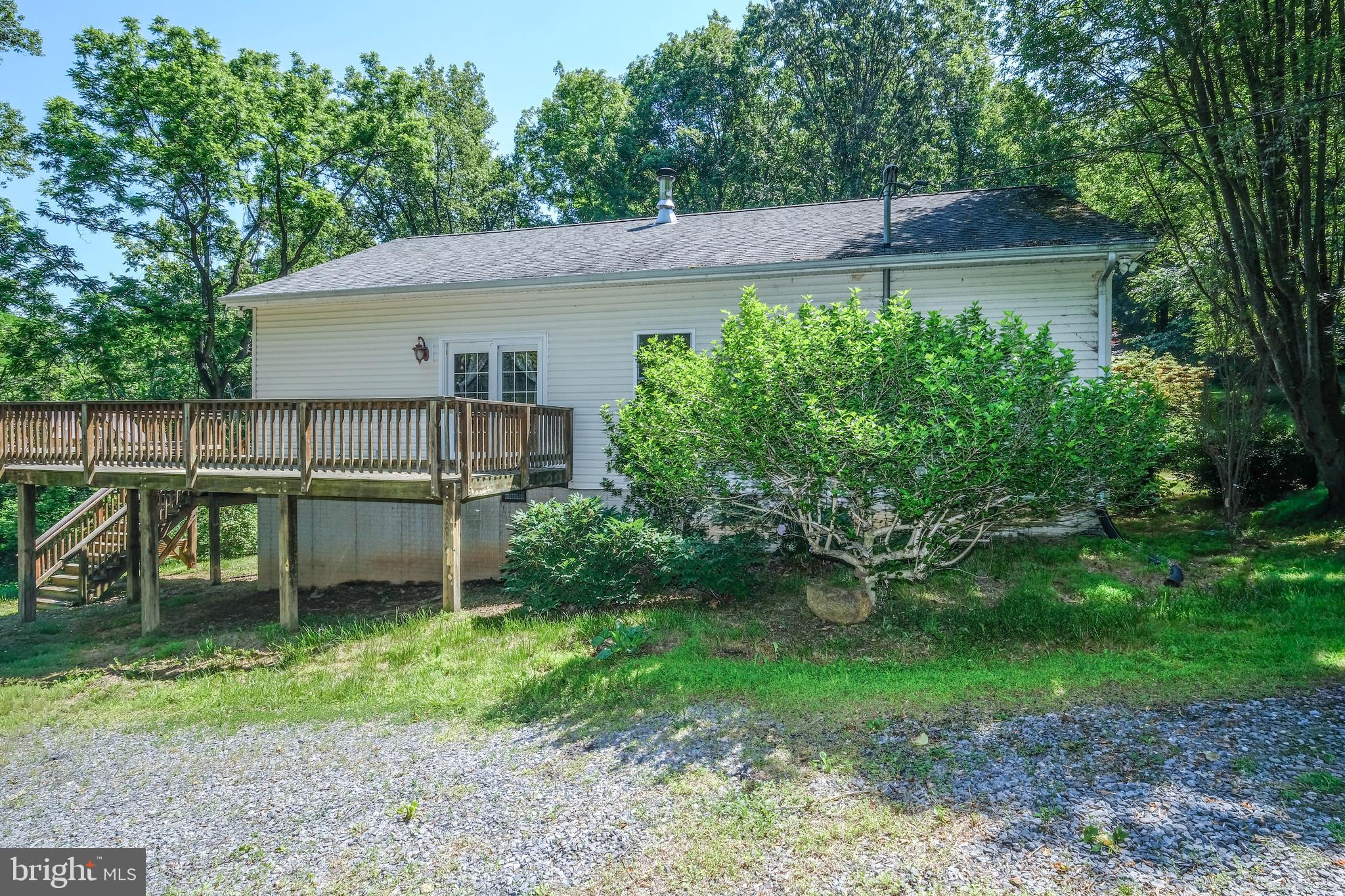 1195 Shangri-La Road Bentonville, VA 22610 - Photo 6 of 64 a backyard of a house with barbeque oven and outdoor seating