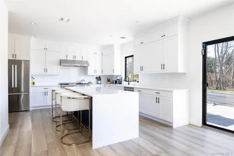 a kitchen with a sink cabinets and wooden floor