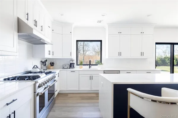 a kitchen with stainless steel appliances granite countertop a sink stove and cabinets