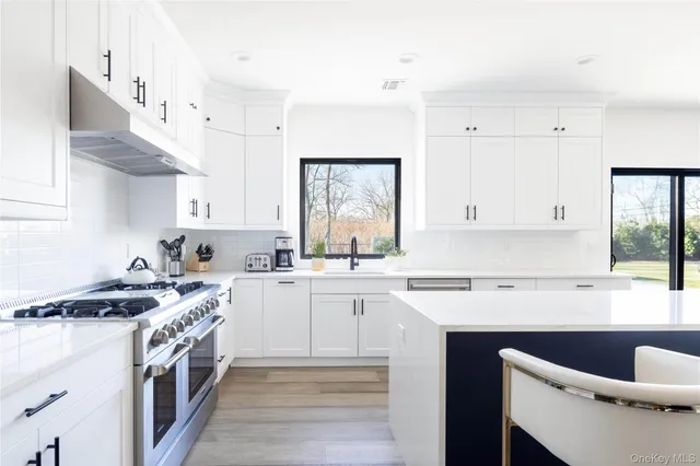 a kitchen with stainless steel appliances granite countertop a sink stove and cabinets